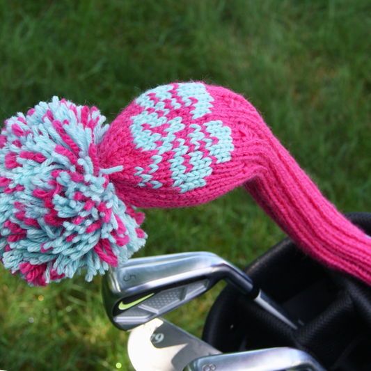 Knit fairway wood cover with pink and blue flower pattern on a grass background