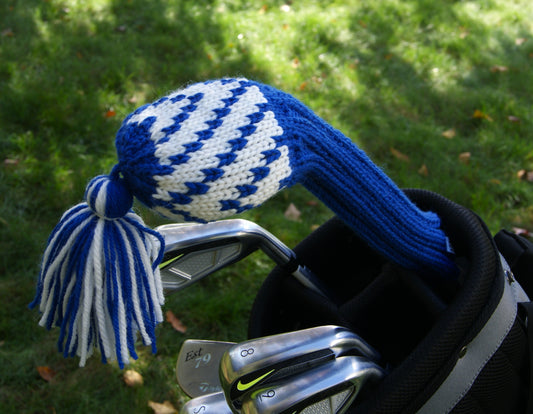 Golf club with a blue and white checkered head cover on a grassy background