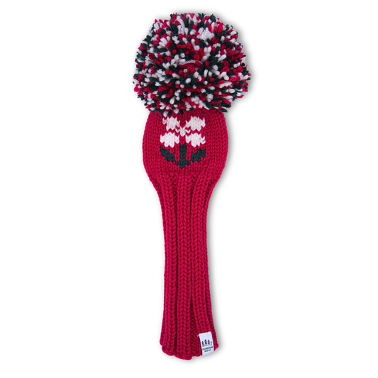 A pink knitted fairway wood cover with a white flower design