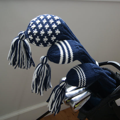 Blue and white patterned golf club covers with tassels in a golf bag