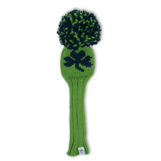 Green golf club head cover with a shamrock design and pom-pom on a white background